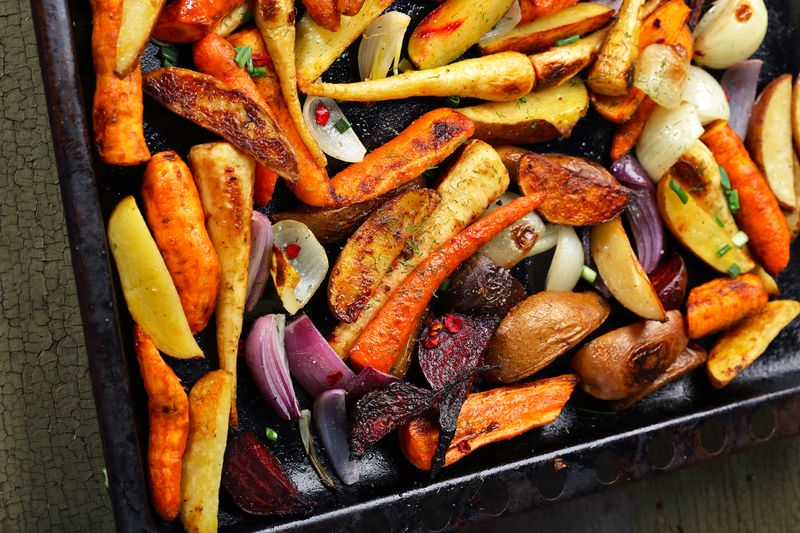 Close-up shot of colorful roasted vegetables on a sheet pan.
