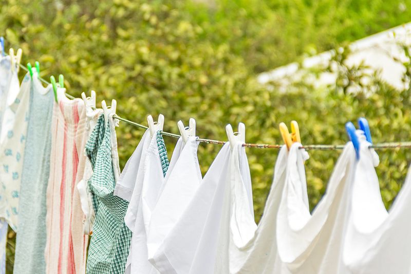 An outdoor clothes line with laundry hanging from it.