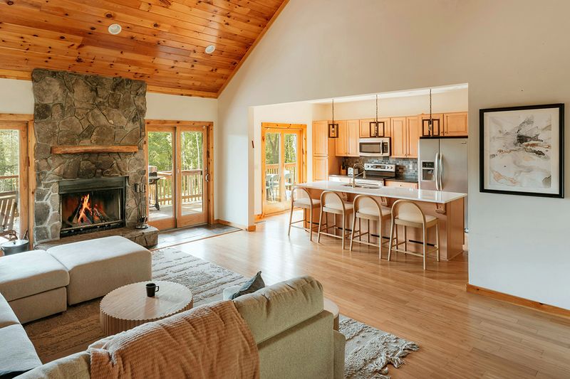 An open-concept living room and kitchen where the wood flooring is the same throughout.