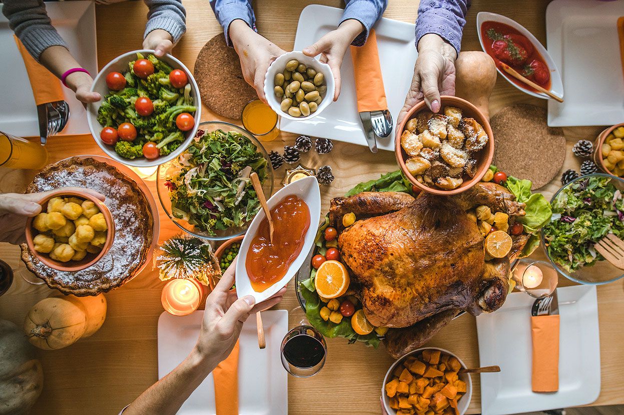 An aerial view of a Thanksgiving table with a turkey and various side dishes