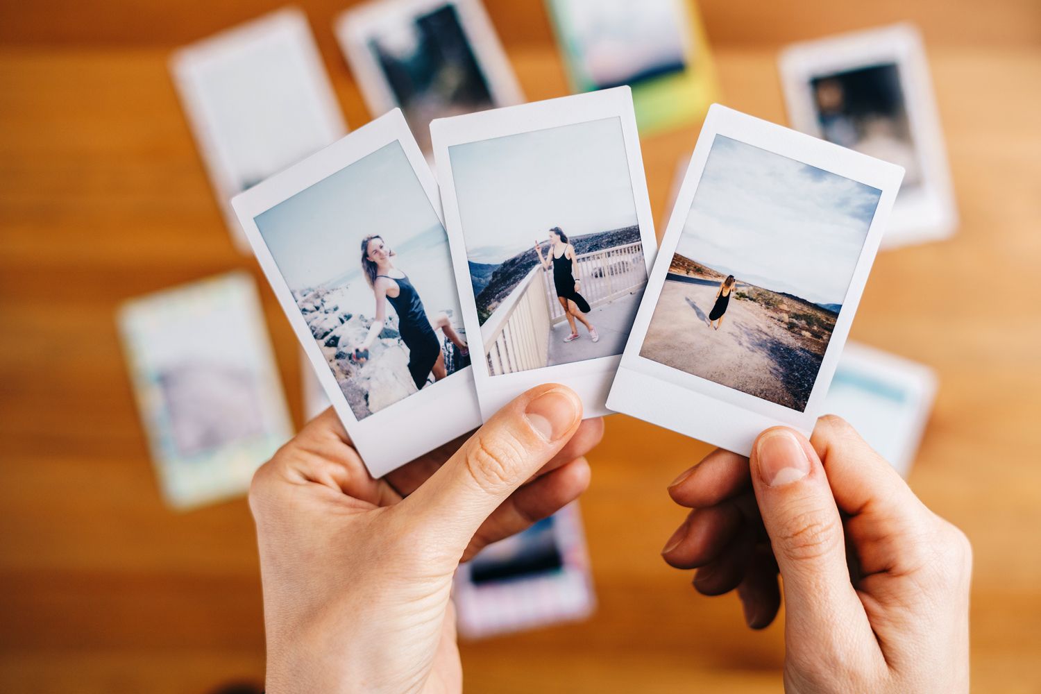 An image of a person holding Polaroid photographs