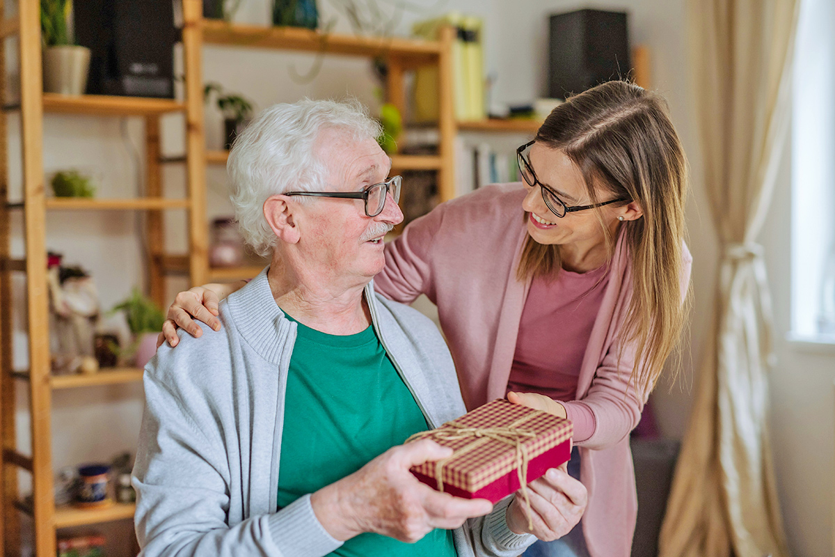 Woman giving father a gift