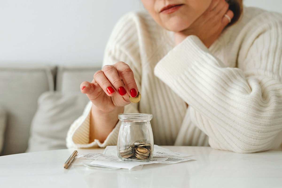 Woman putting coins in jar