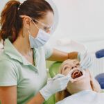 Dentist looking in a patient's mouth