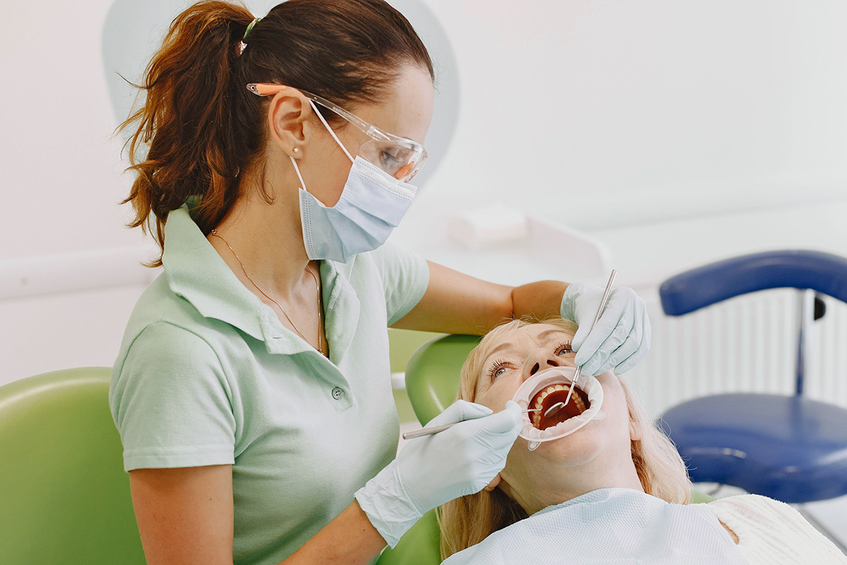 Dentist looking in a patient's mouth