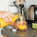 Woman pouring orange juice