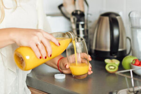 Woman pouring orange juice