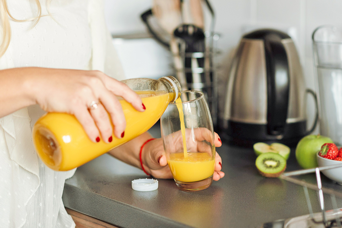 Woman pouring orange juice
