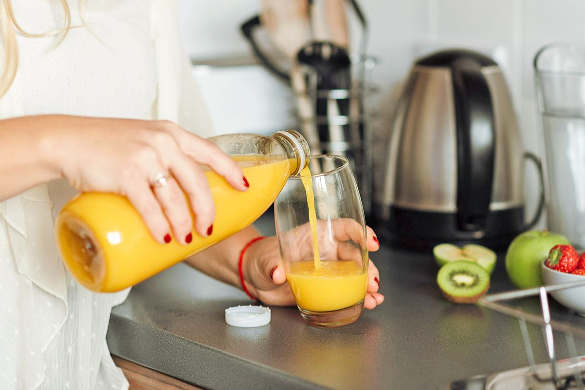 Woman pouring orange juice