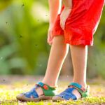 Legs with bugs flying around