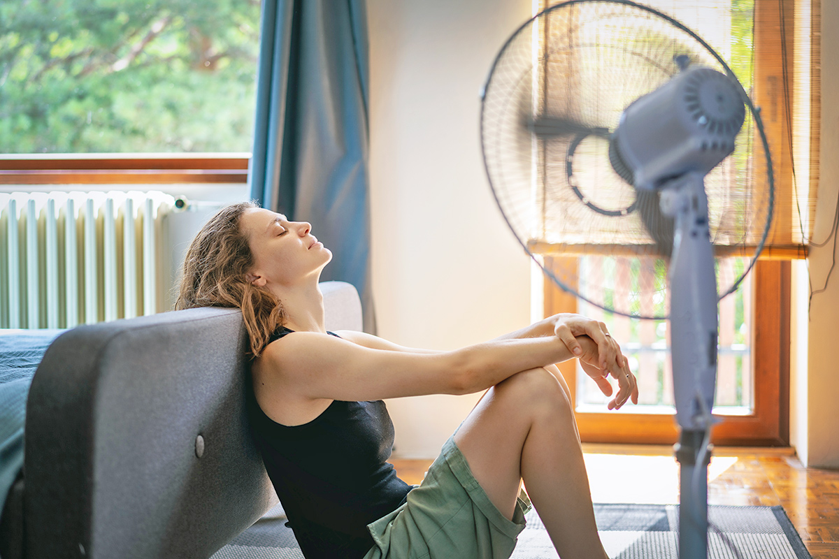 Woman in front of fan
