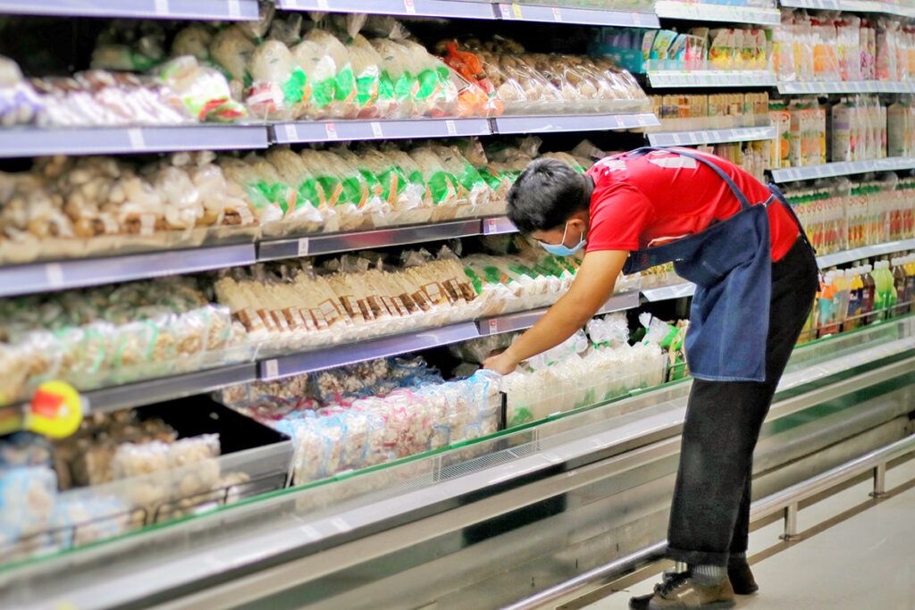 Grocery store employee restocking