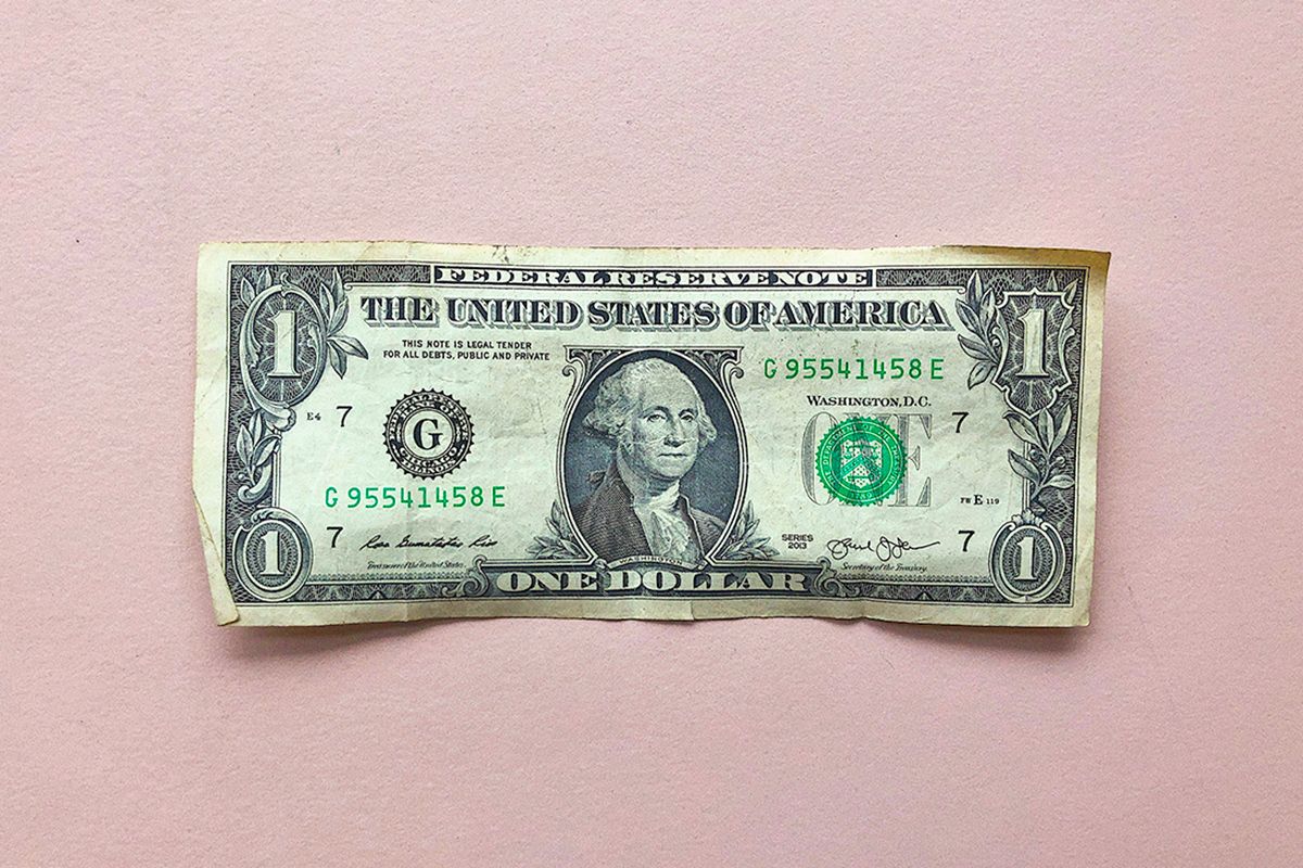 $1 bill on pink background