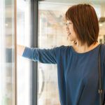 Woman reaching into freezer at store