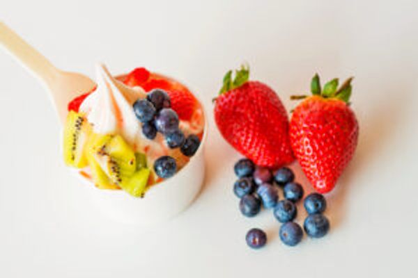 Frozen yogurt and fruit on a table