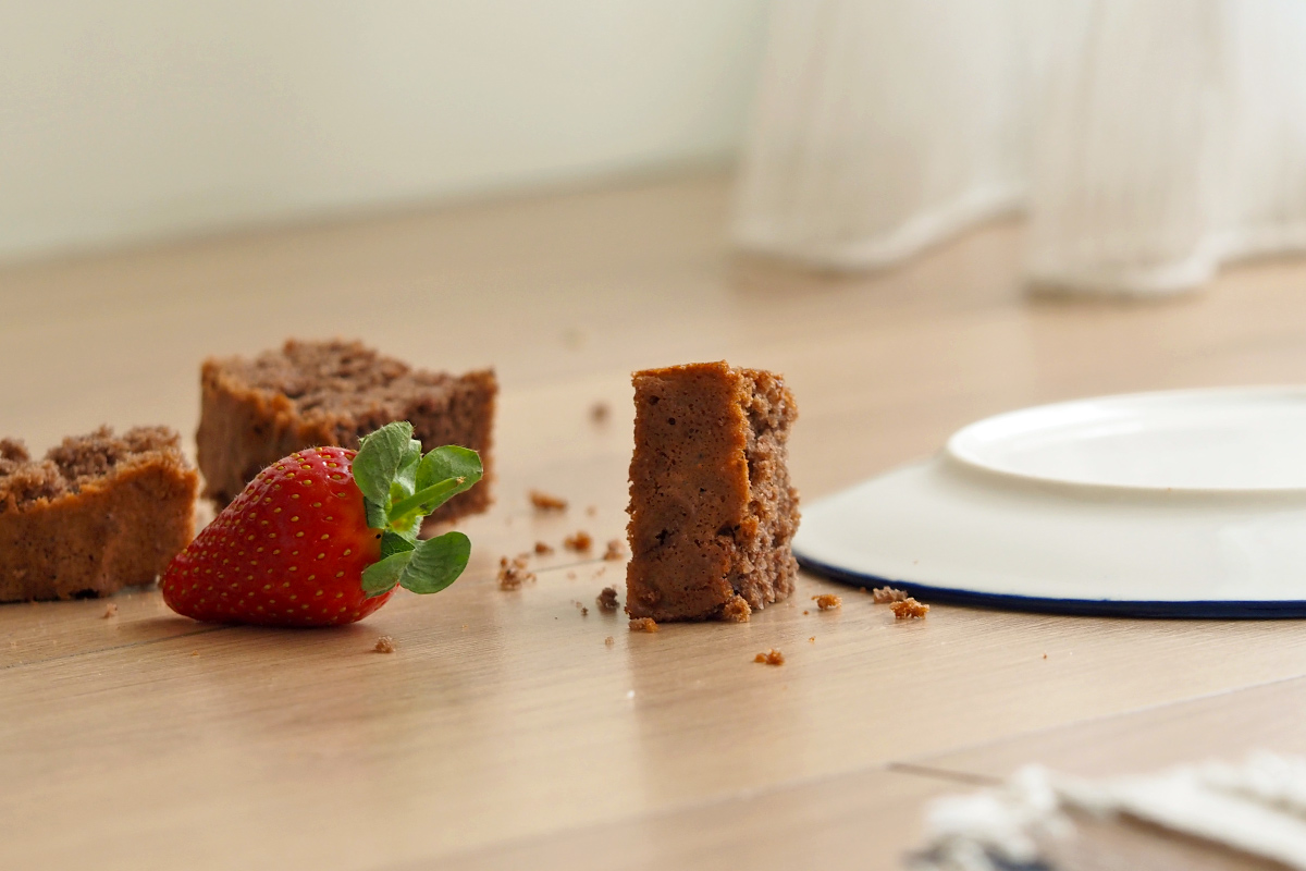 Brownies and a strawberry on the floor