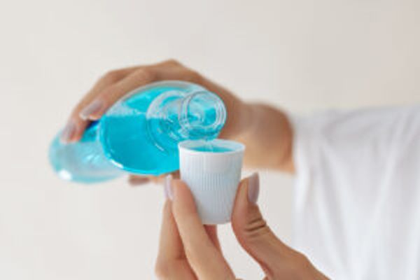 Pouring mouthwash in cap
