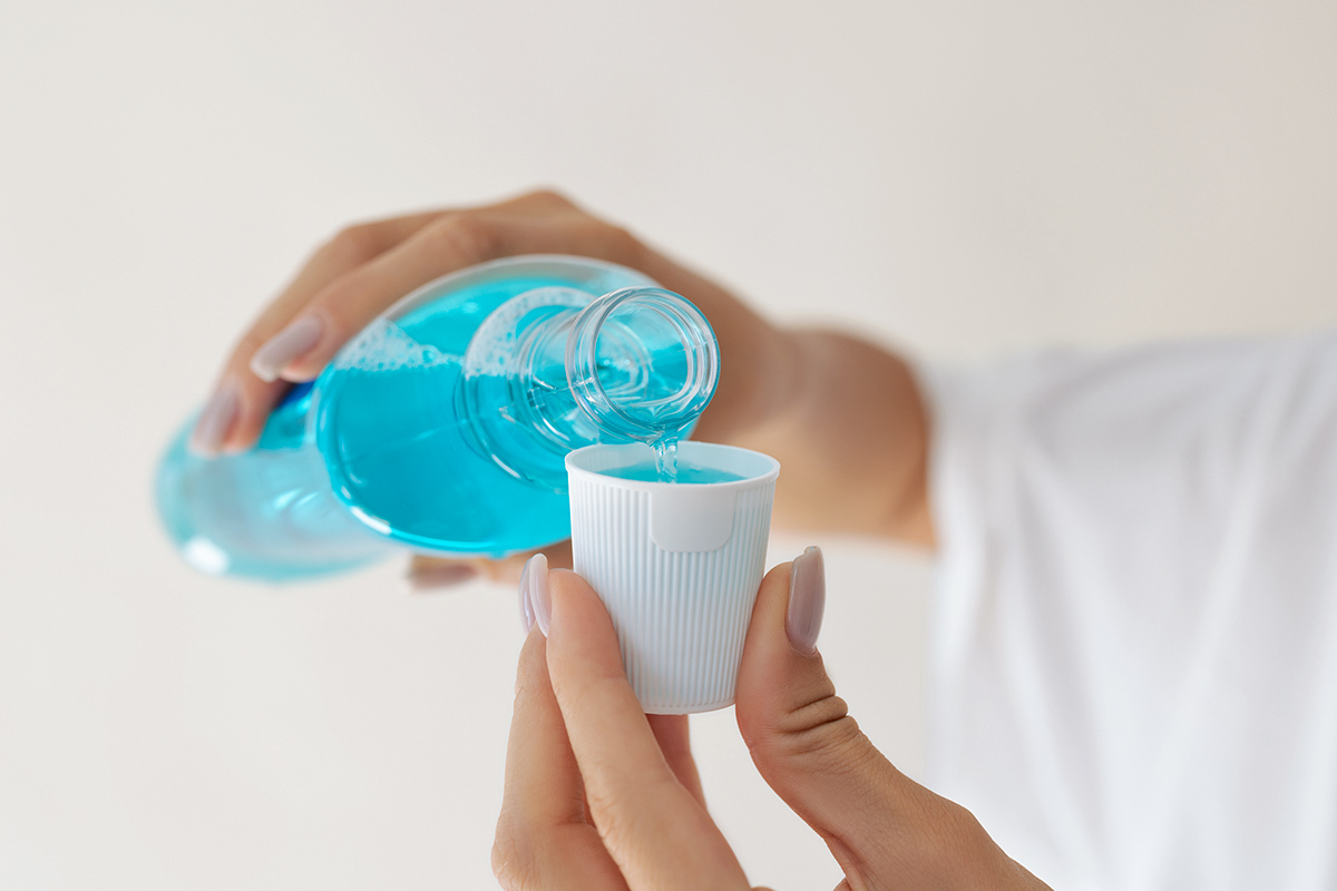 Pouring mouthwash in cap