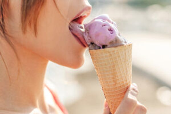 Woman licking ice cream cone