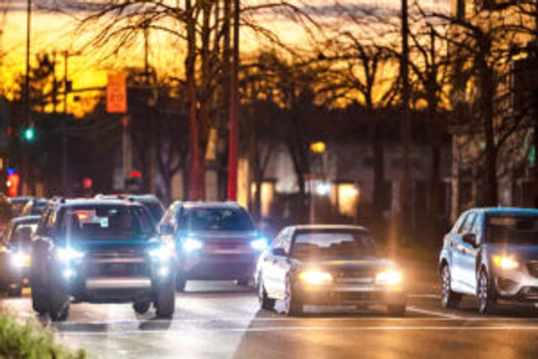 Cars with headlights on on a road