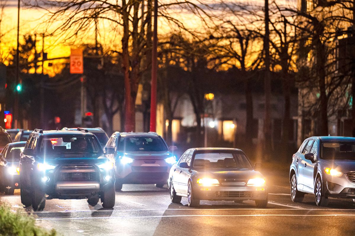 Cars with headlights on on a road