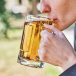 Person sipping beer