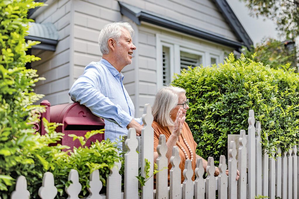 Older couple next to a fence