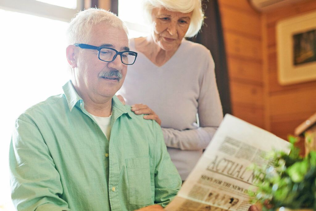 Older couple reading newspaper
