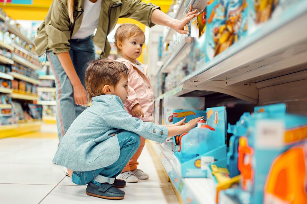 Kids reaching for toys in the toy aisle