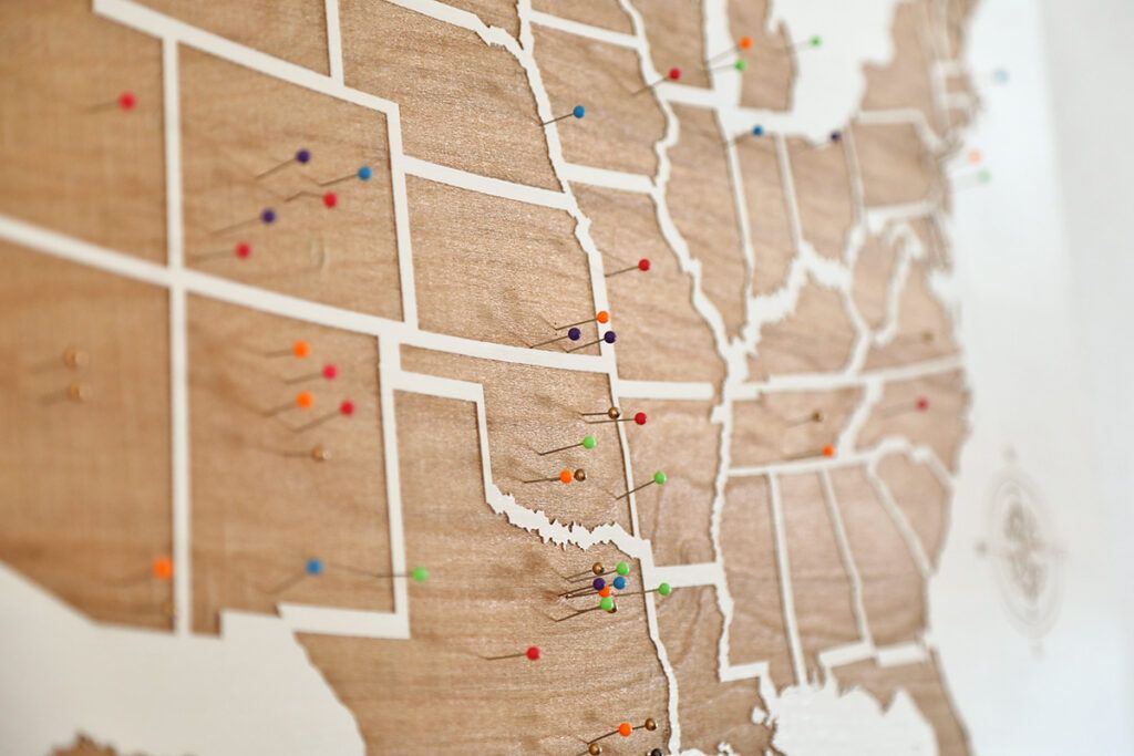 Map of the U.S. on a wall with pins in each state