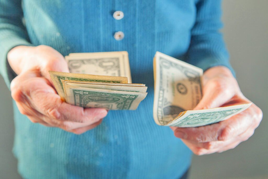 Hands holding $1 bills