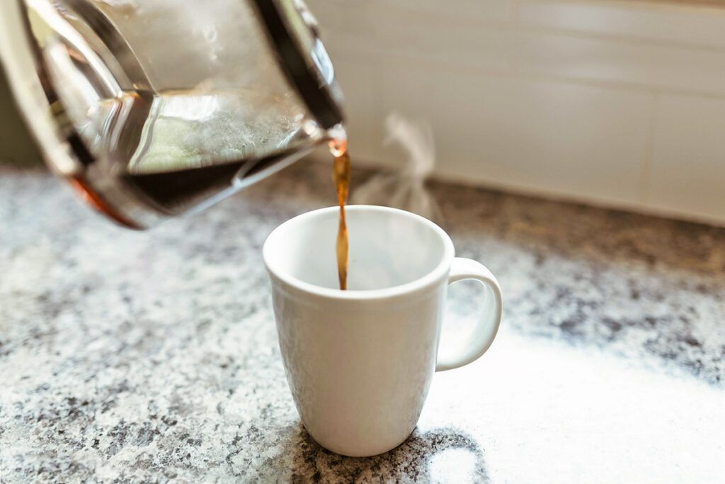Pouring coffee in a cup