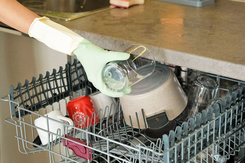 Person loading dishwasher
