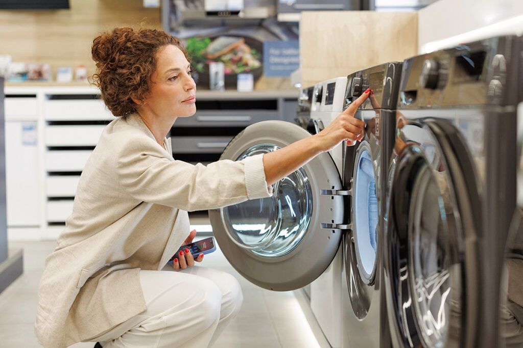 Woman looking at washing machines