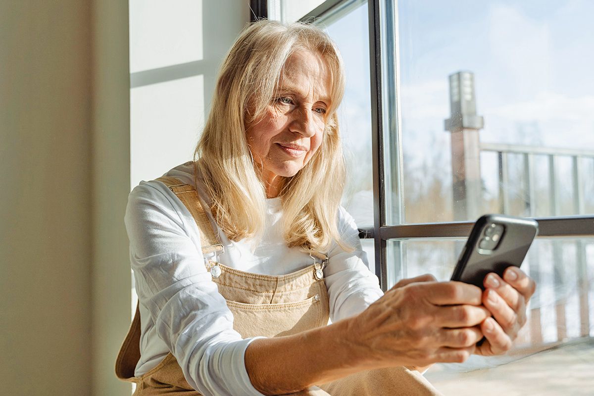 Older woman looking at cell phone
