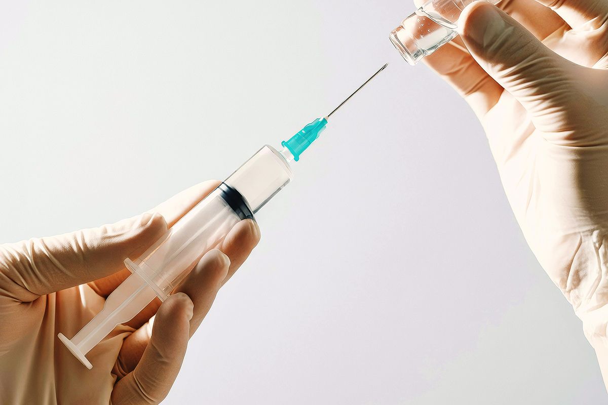 Syringe and bottle of liquid