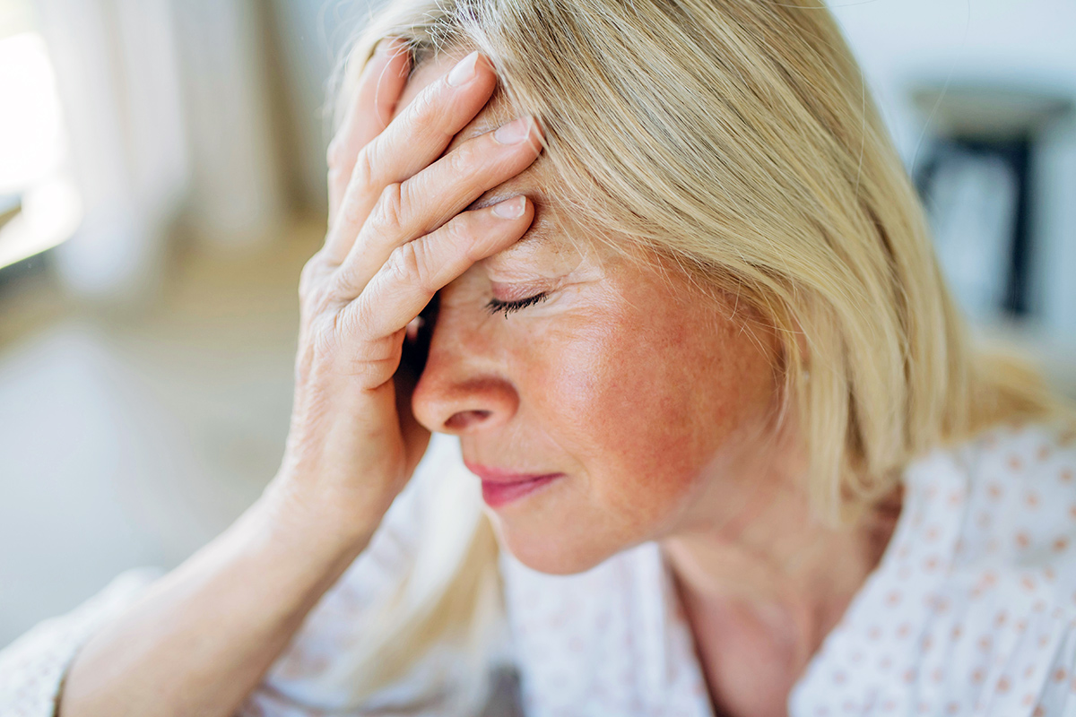 Woman with hand on forehead