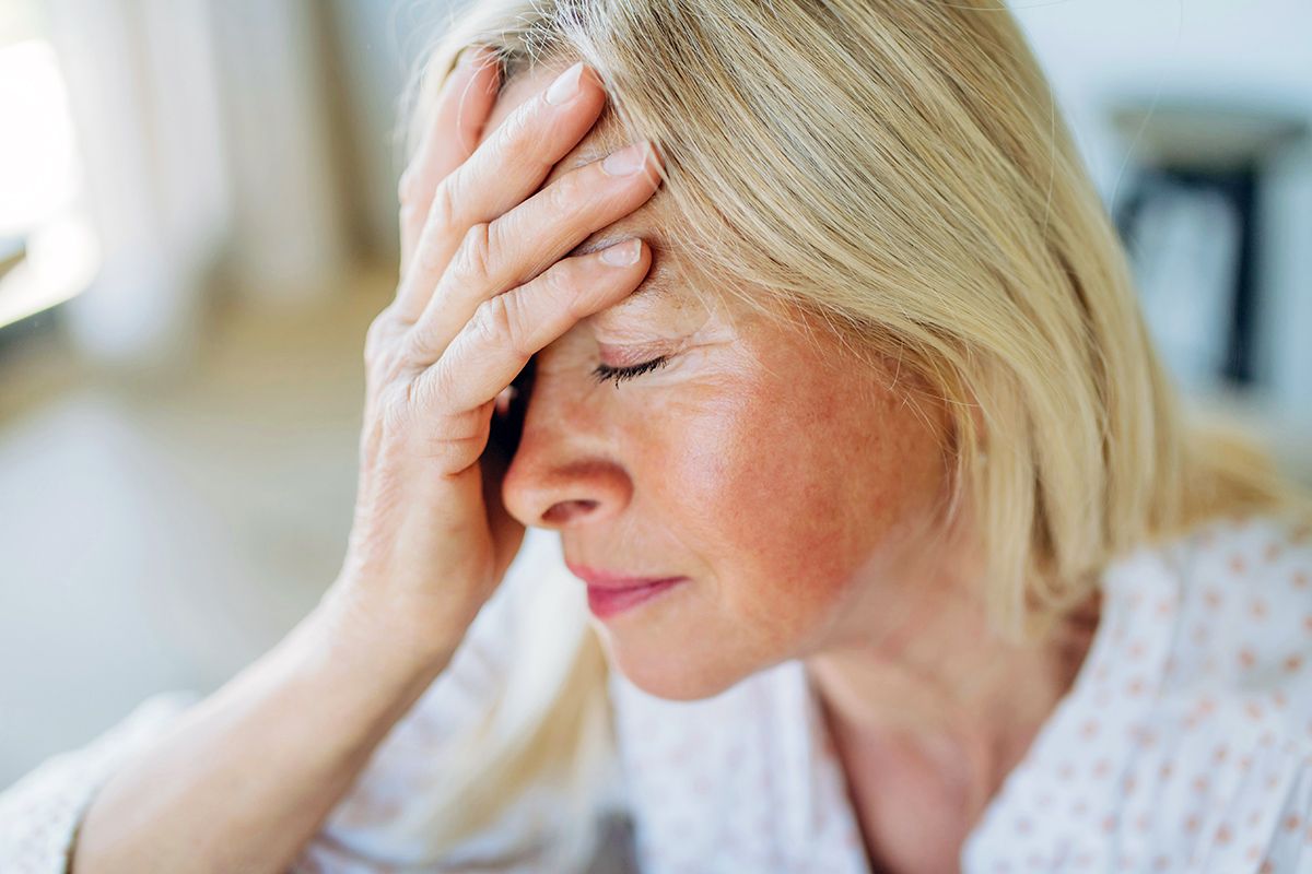 Woman with hand on forehead