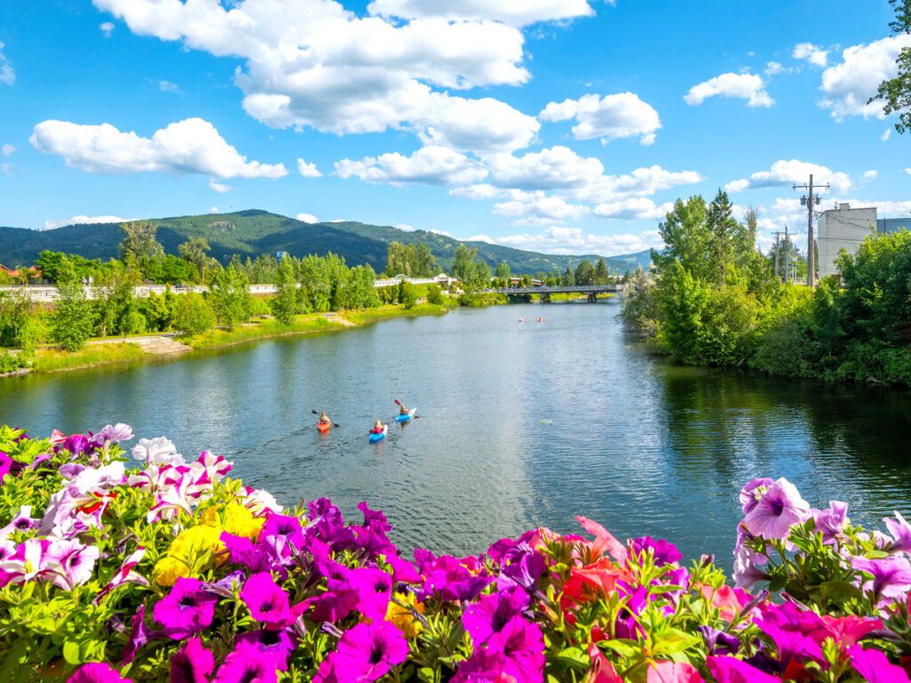 Colorful flowers framing canoers on lake in Sandpoint, Idaho