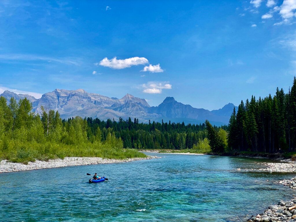 Person paddling canoe on lake in Whitefish, Montana