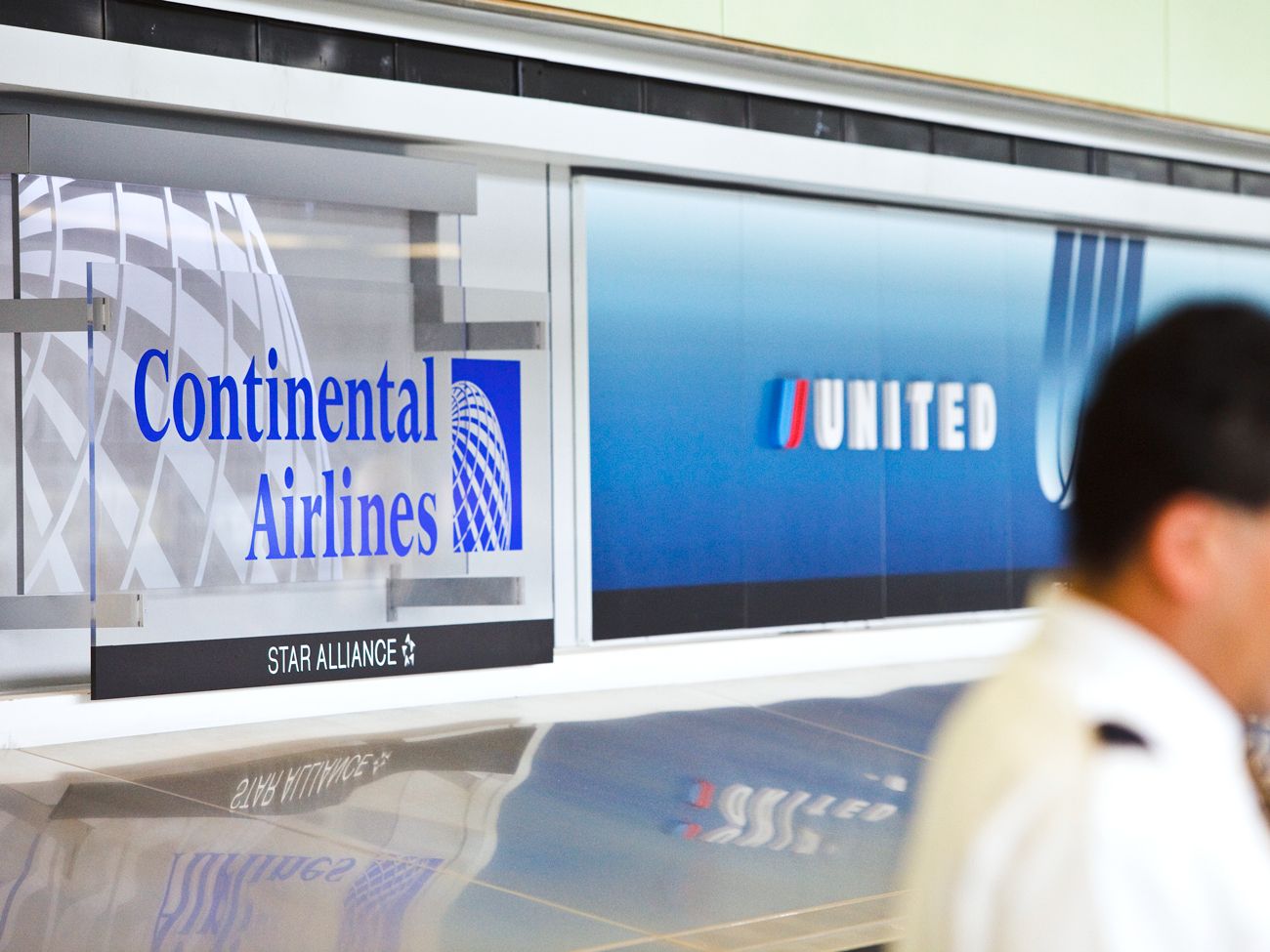 Continental and United Airlines signage at airport check-in counter