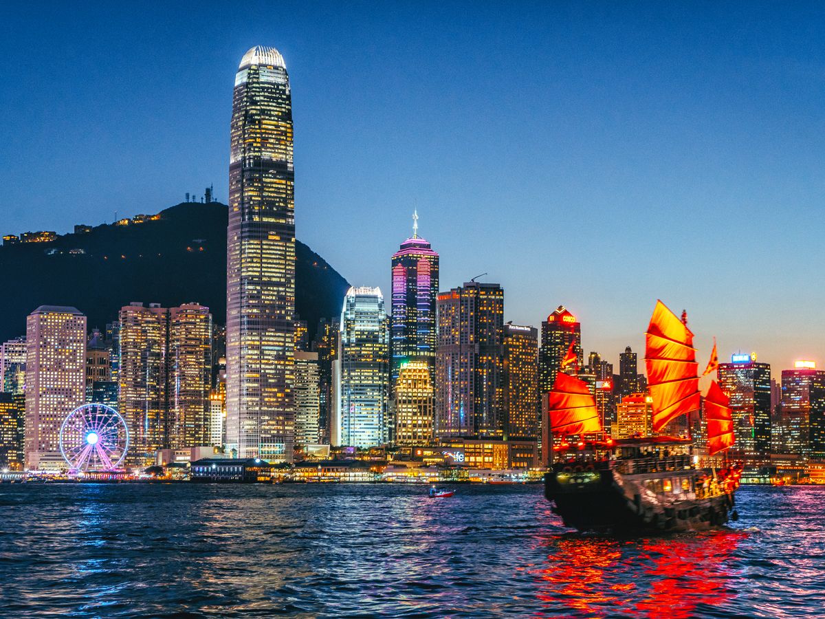Junkboat and skyline of Hong Kong at night