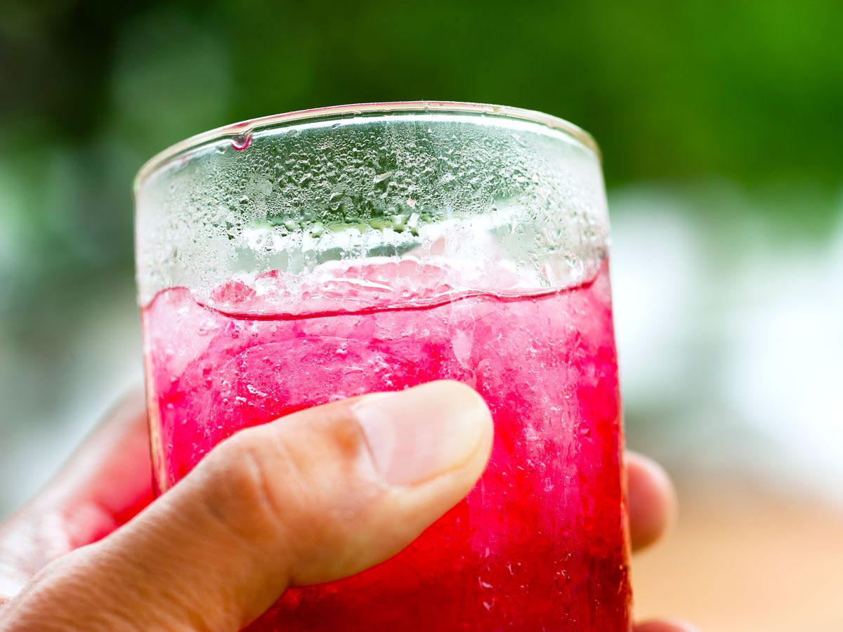 Person holding glass of Kool-Aid