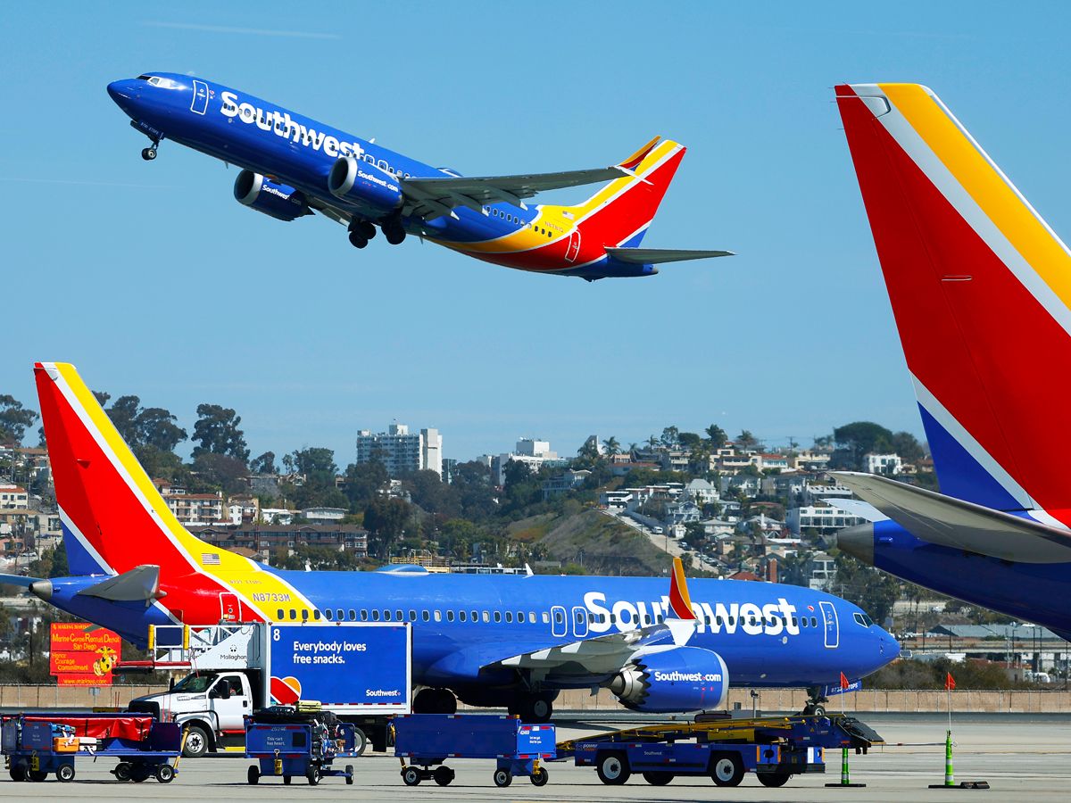 Southwest Airlines Boeing 737 taking off as another taxies by