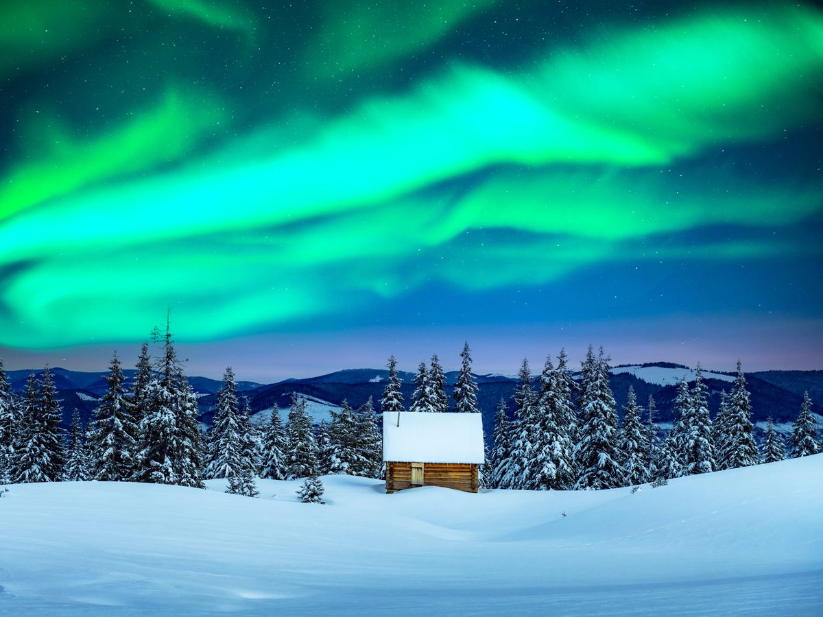 Northern lights above snowy landscape of Swedish Lapland