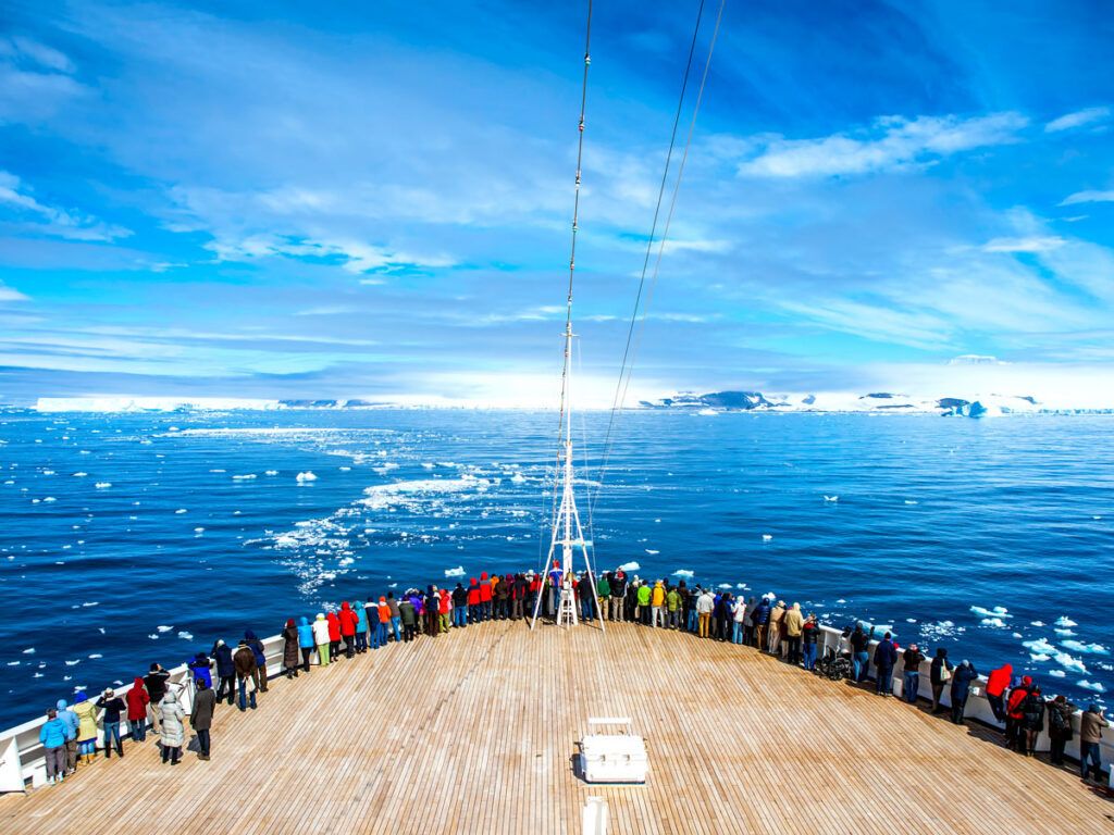 Passengers on bow of cruise ship in Antarctica