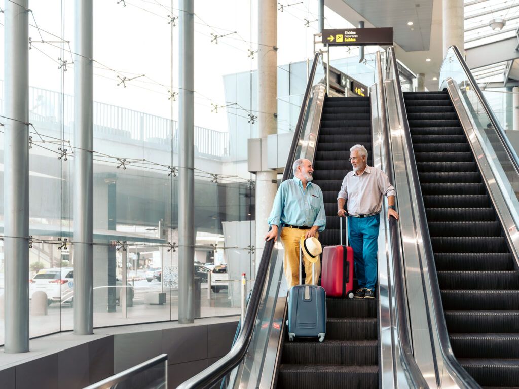 Travelers on escalator in airport terminal