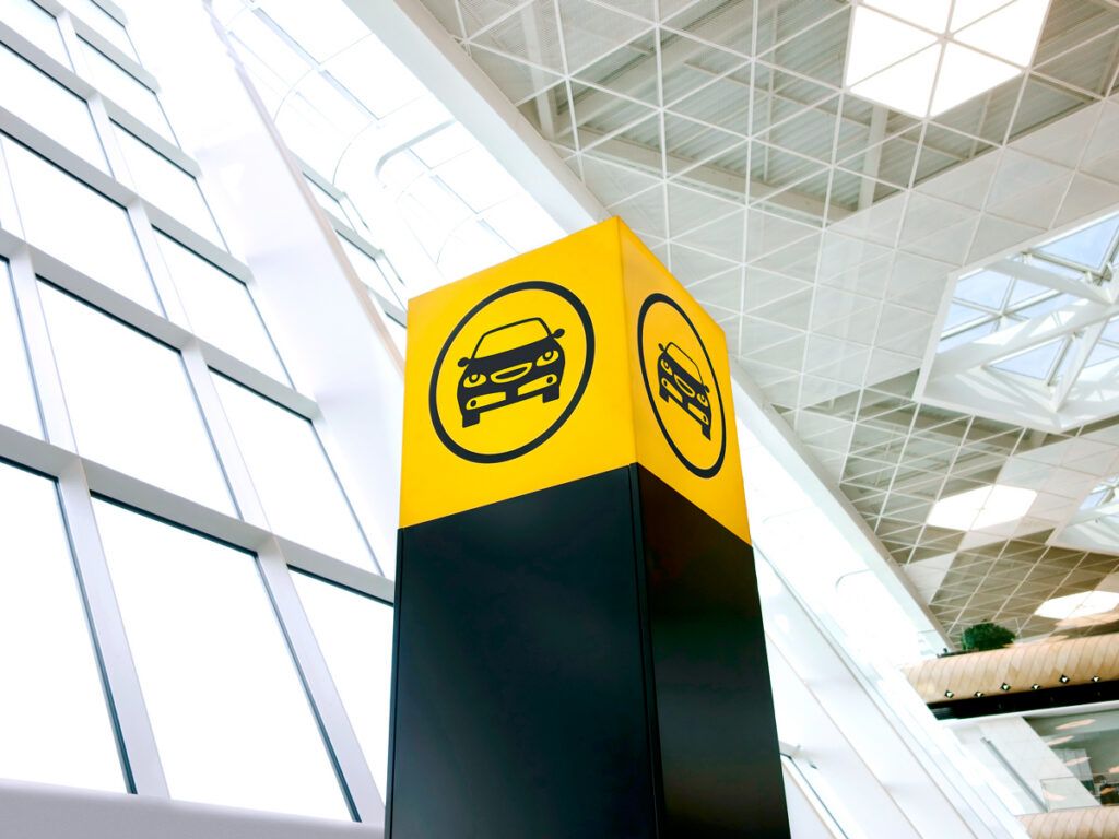 Sign for car rentals in airport terminal