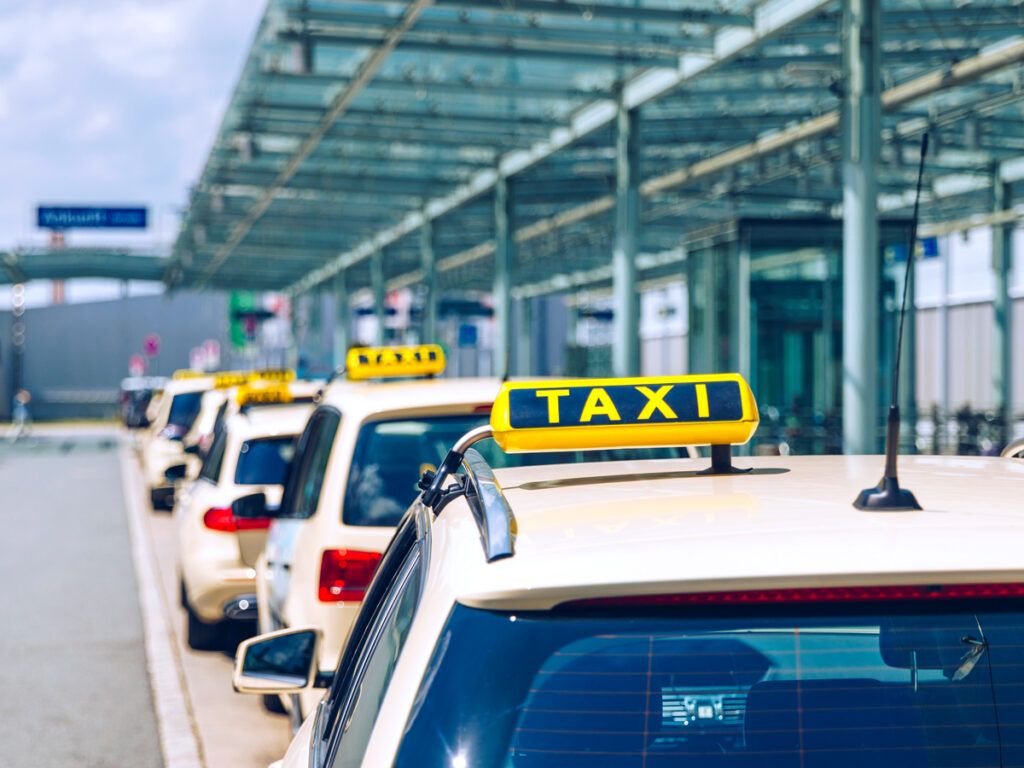 Line-up of taxis at airport terminal