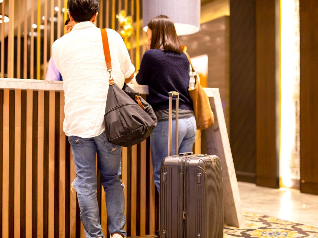 Two guests at hotel check-in desk